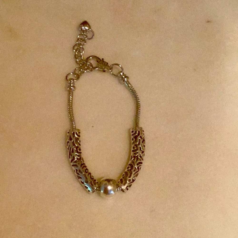 Elegant Silver Tone Bracelet with Intricate Design